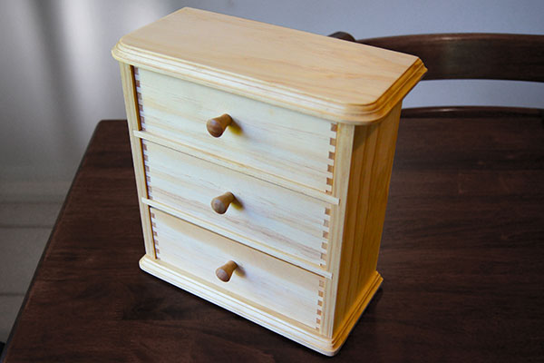 Wooden jewellery box with three drawers